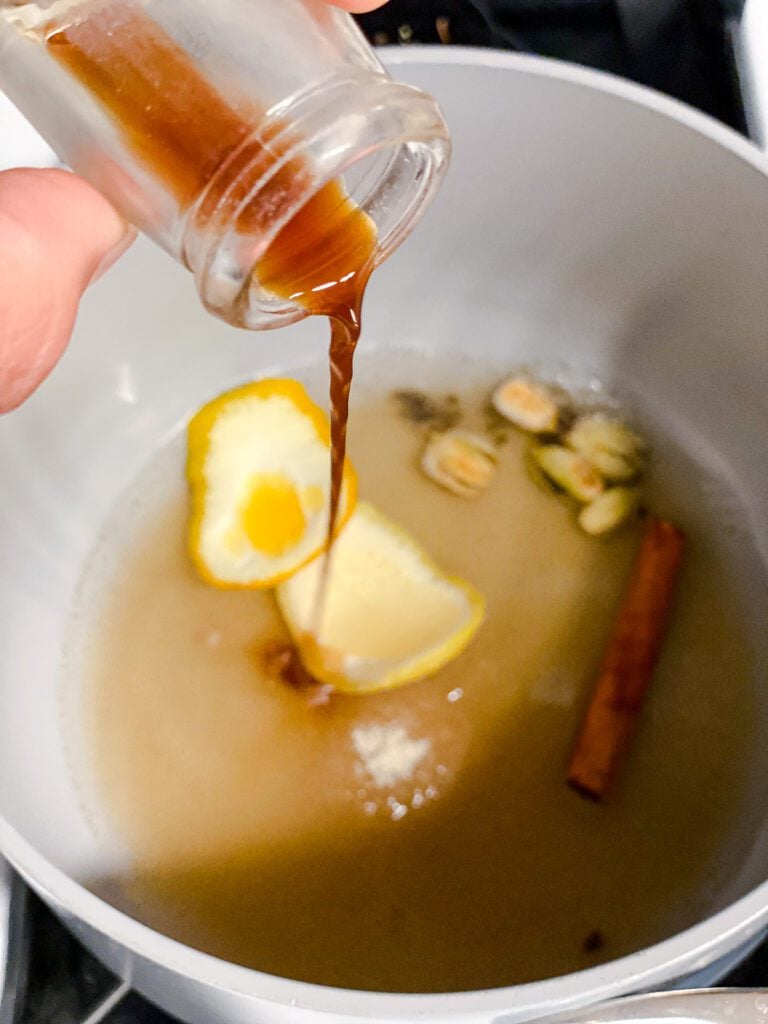 process shot of adding vanilla extract to pot