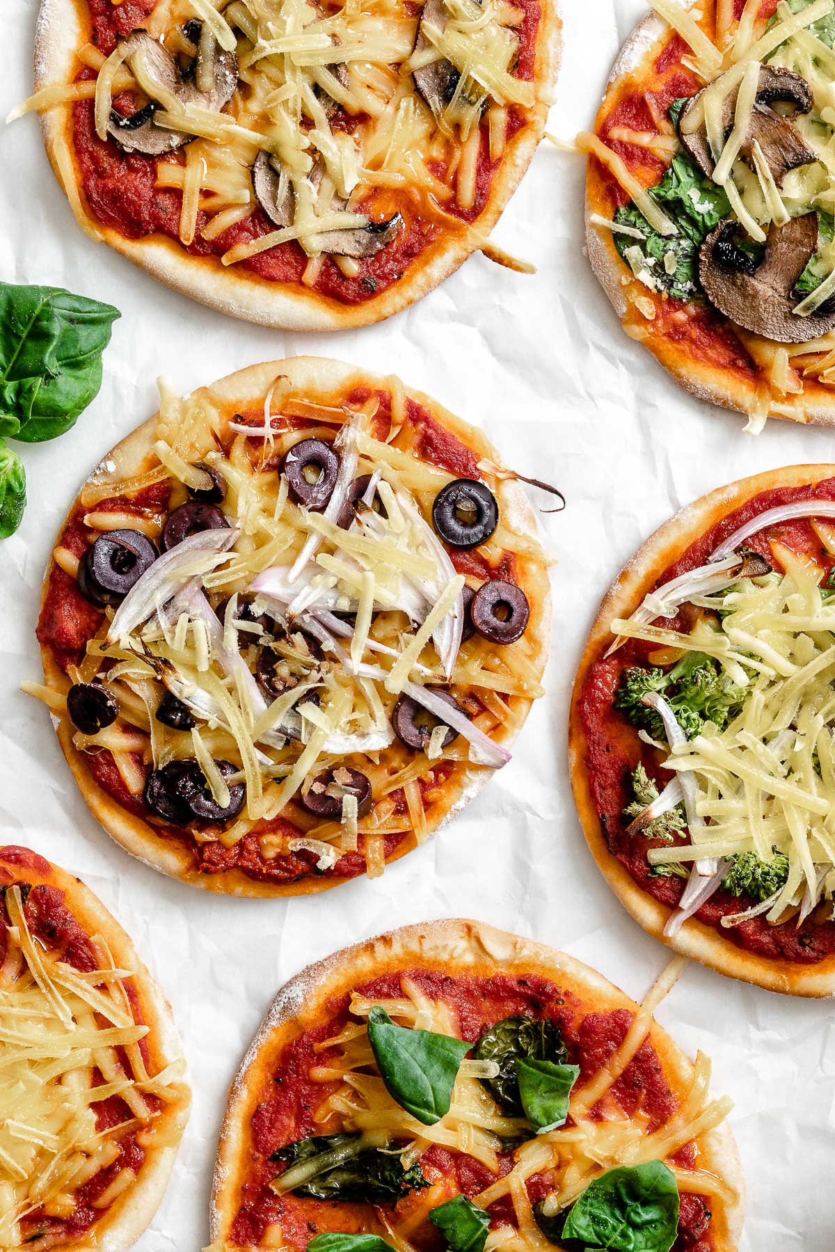 several completed Flatbread Mini Pizzas on a white surface