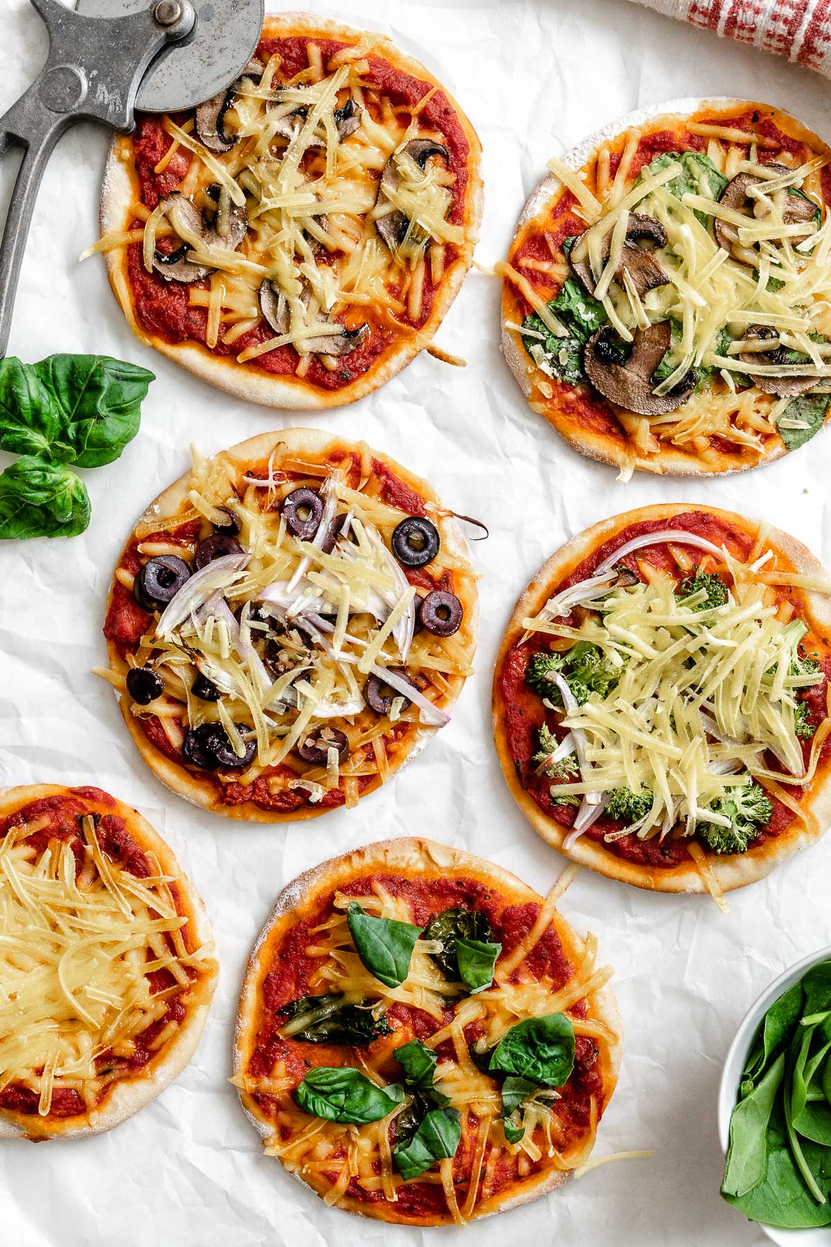 several completed Flatbread Mini Pizzas on a white surface