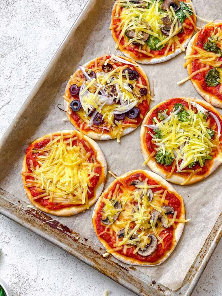 several completed Flatbread Mini Pizzas on a white surface