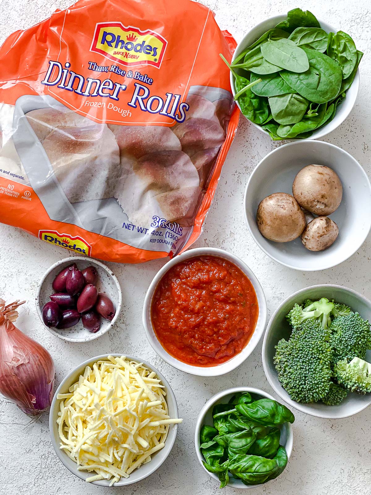 ingredients for Flatbread Mini Pizzas measured out on a white surface