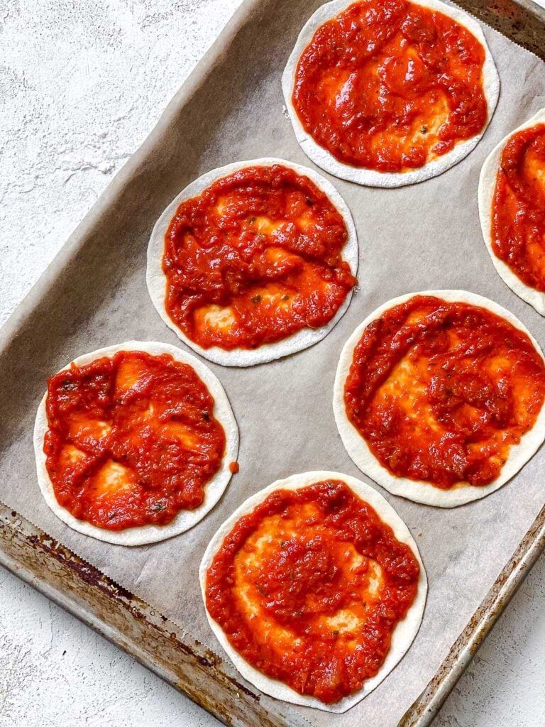 tomato added to dough on baking sheet