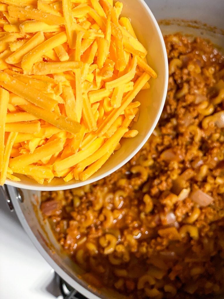 process shot of adding vegan cheese to pan