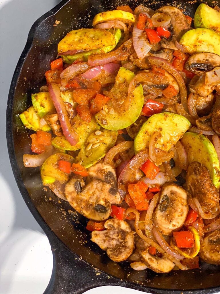 process shot showing vegetables cooking in skillet