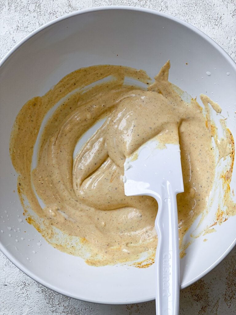 process shot of mixing ingredients together in a bowl