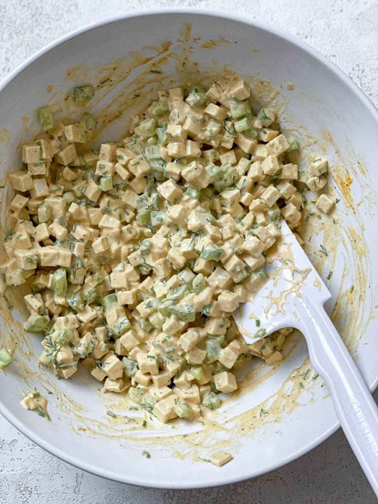 process shot of mixing ingredients together in a bowl