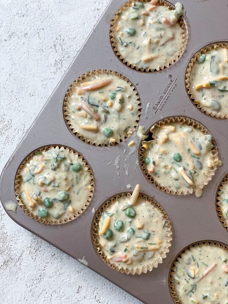 process shot showing addition of Healthy Veggie Muffins batter in muffin tin