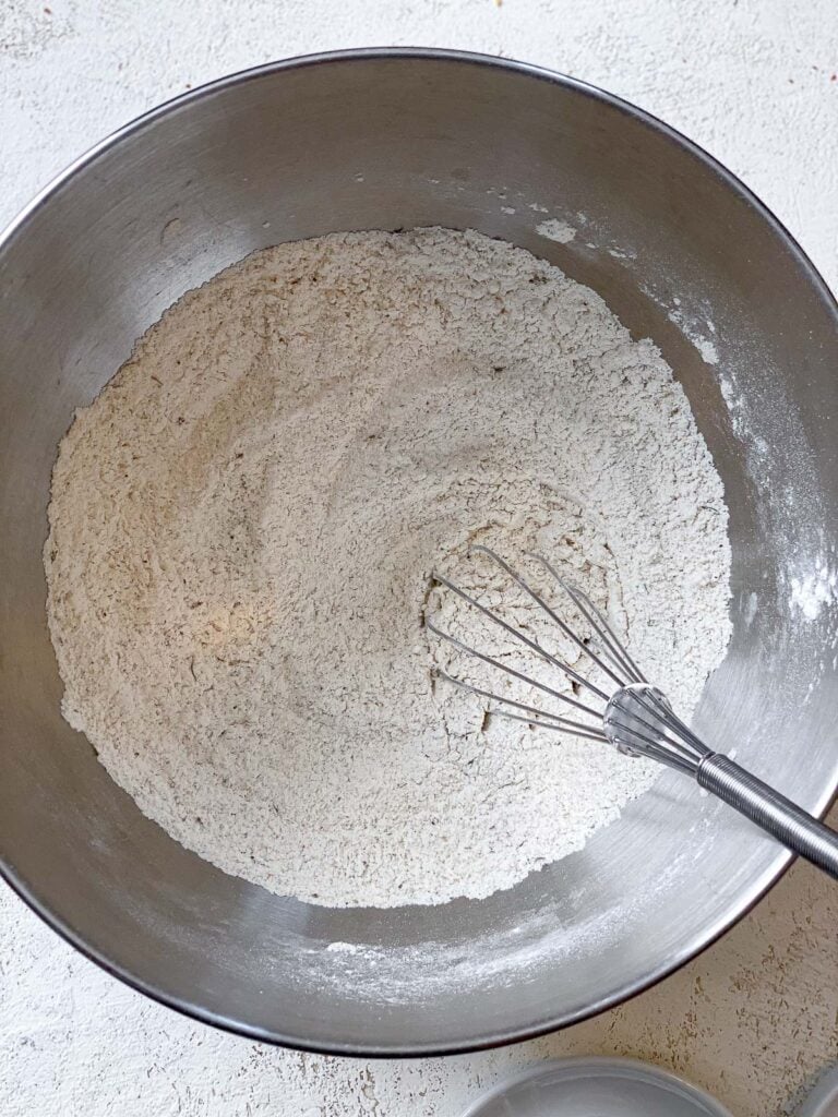 process shot of mixing dry ingredients in a stainless steel bowl