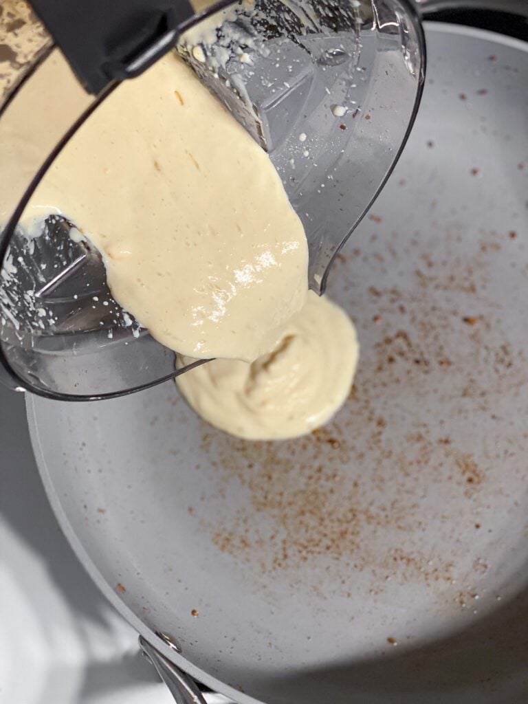 process shot of pouring blended ingredients to pan