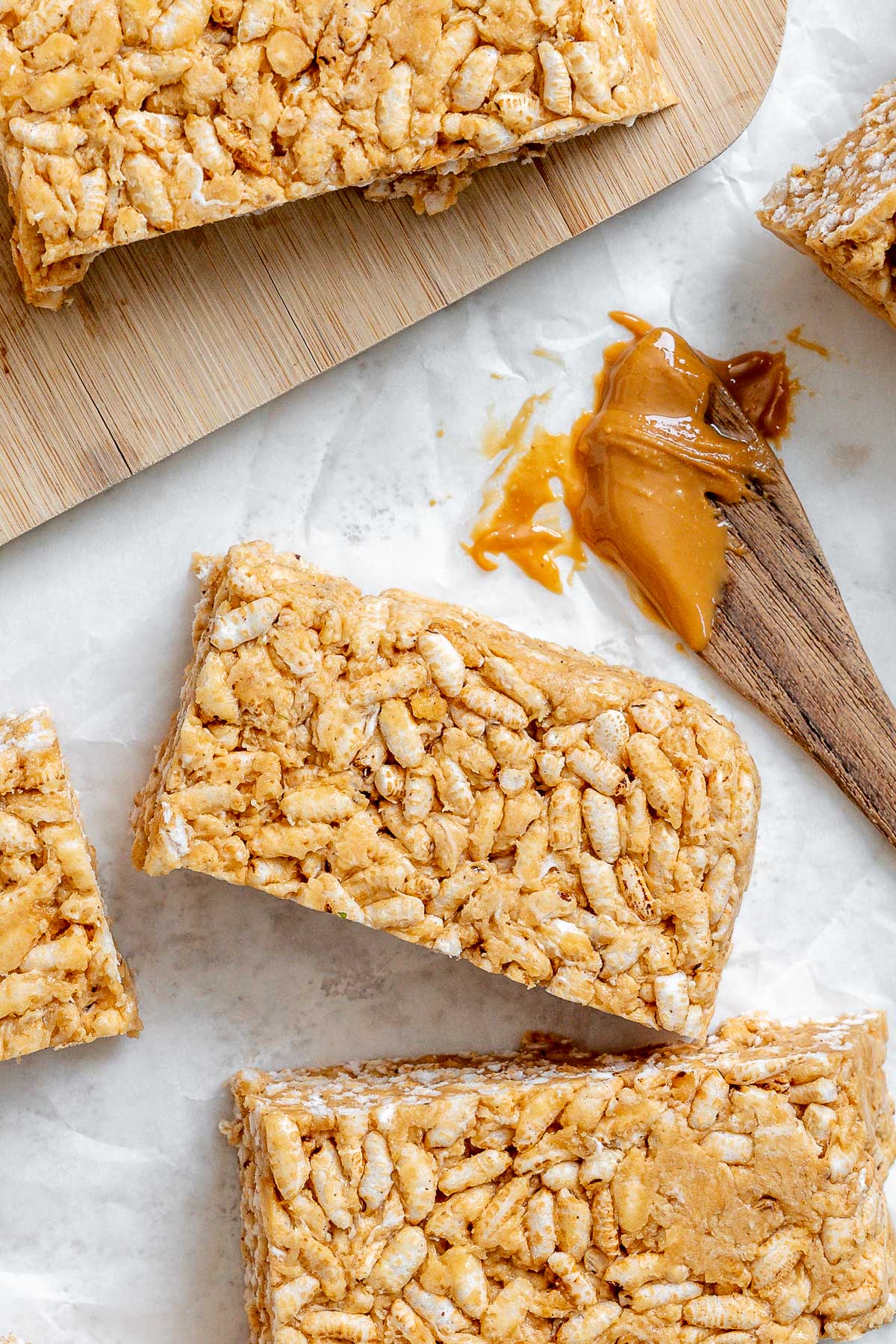 several completed Peanut Butter Rice Krispie Treats against a white surface