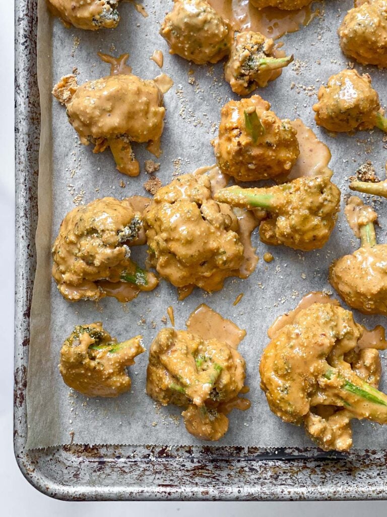 sauce coated broccoli in baking tray