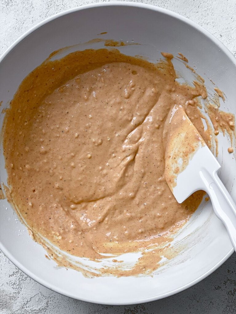 process shot of mixing ingredients together in a bowl