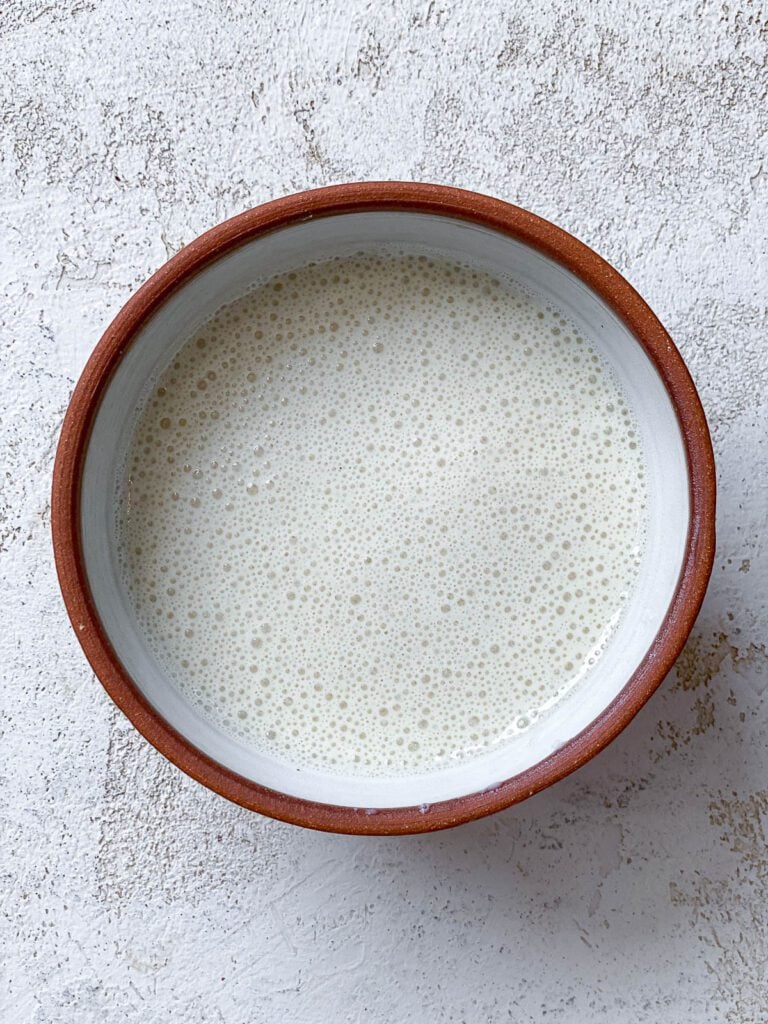 process shot of mixed plant milk and ACV in a bowl