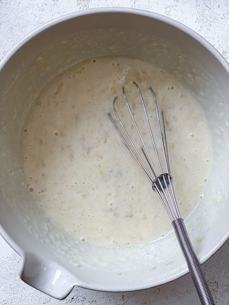process shot of mixing wet ingredients together in a bowl