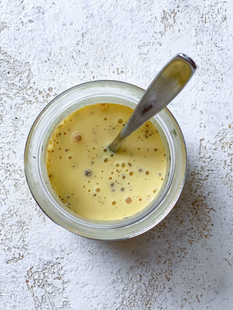 process shot of mixing ingredients together in a glass container