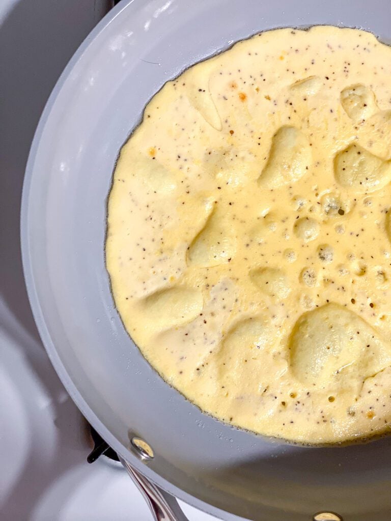 process shot of omelette cooking in pan