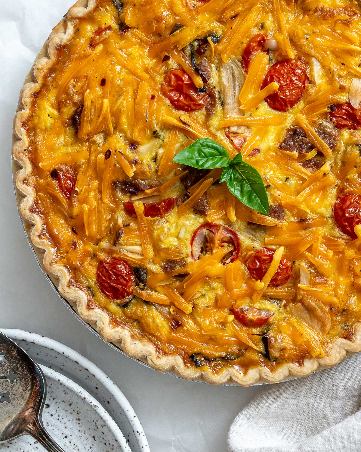completed just egg quiche against a whtie surface