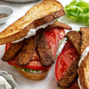 completed vegan blt on white surface
