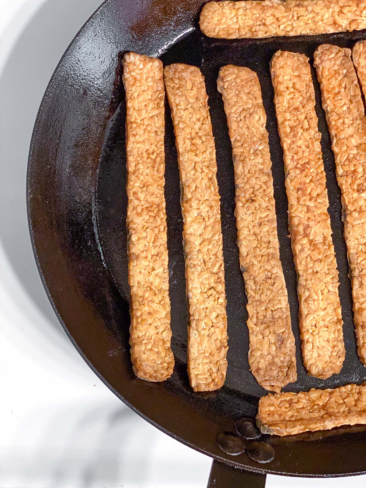 process shot of tempeh cooking in pan