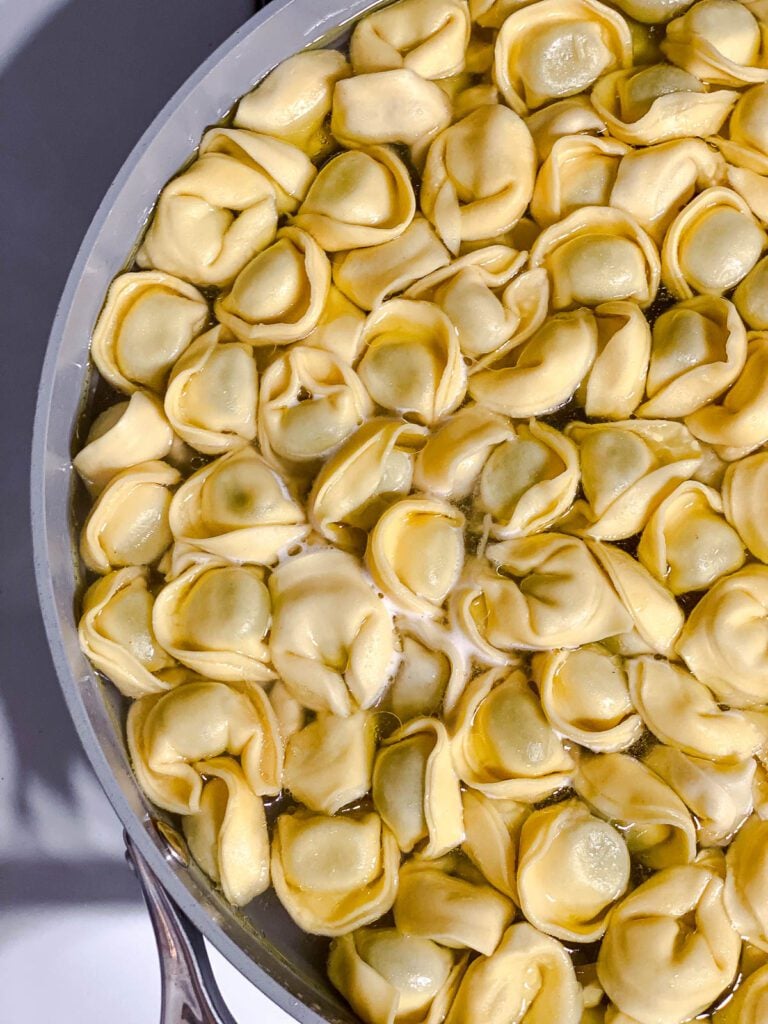 tortellini pasta cooking in pan