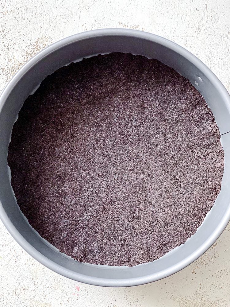 process shot showing leveling of oreo mixture in pan