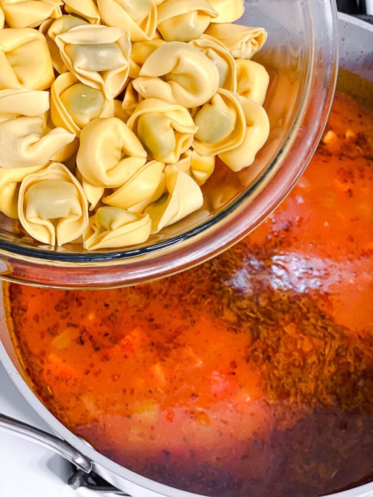process shot of adding tortellini to pot