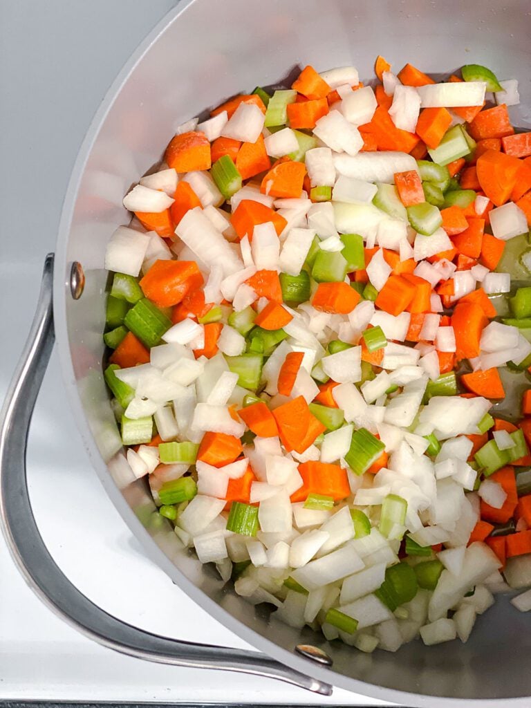process shot of adding veggies to pot