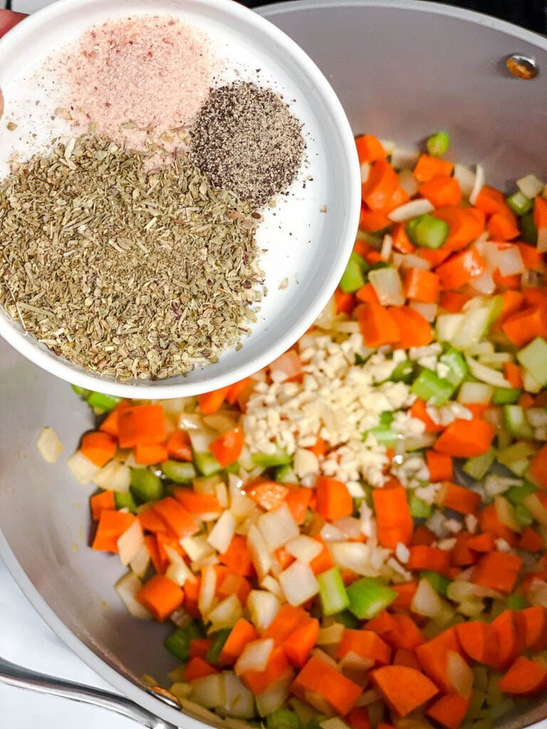 process shot of adding spices to pot