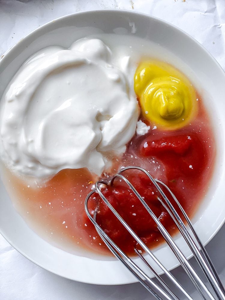 process shot showing ingredients being whisked in bowl