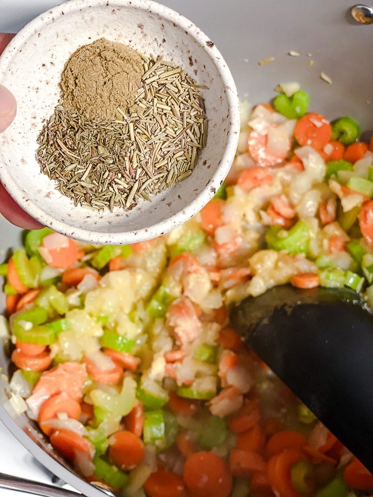 process shot of adding seasonings to pot