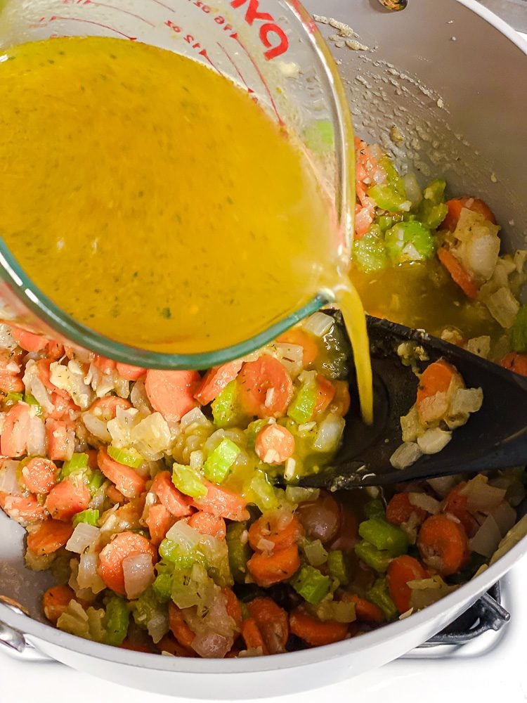 process shot of adding vegan broth to pot