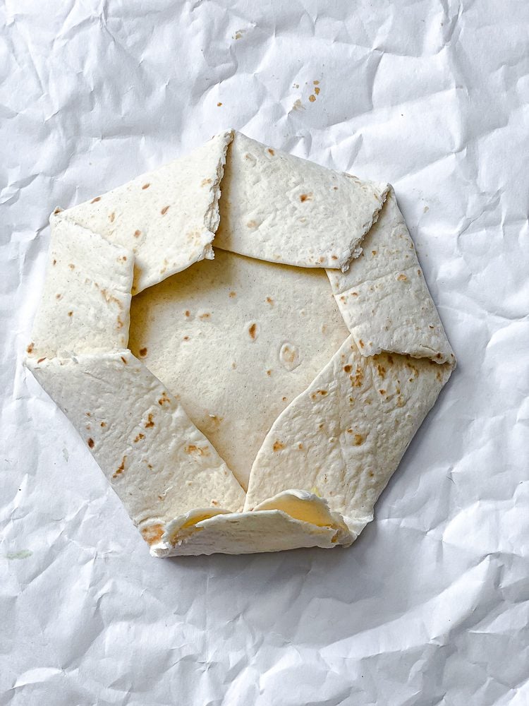 process shot showing how to fold crunchwrap together