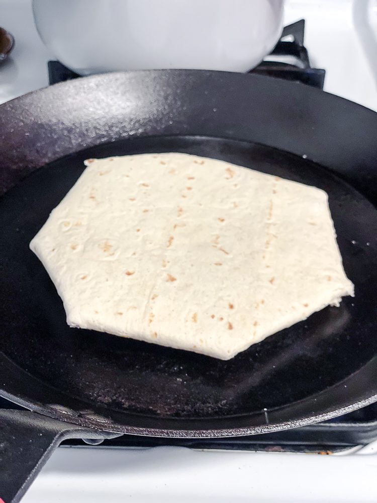 process shot showing crunchwrap on pan
