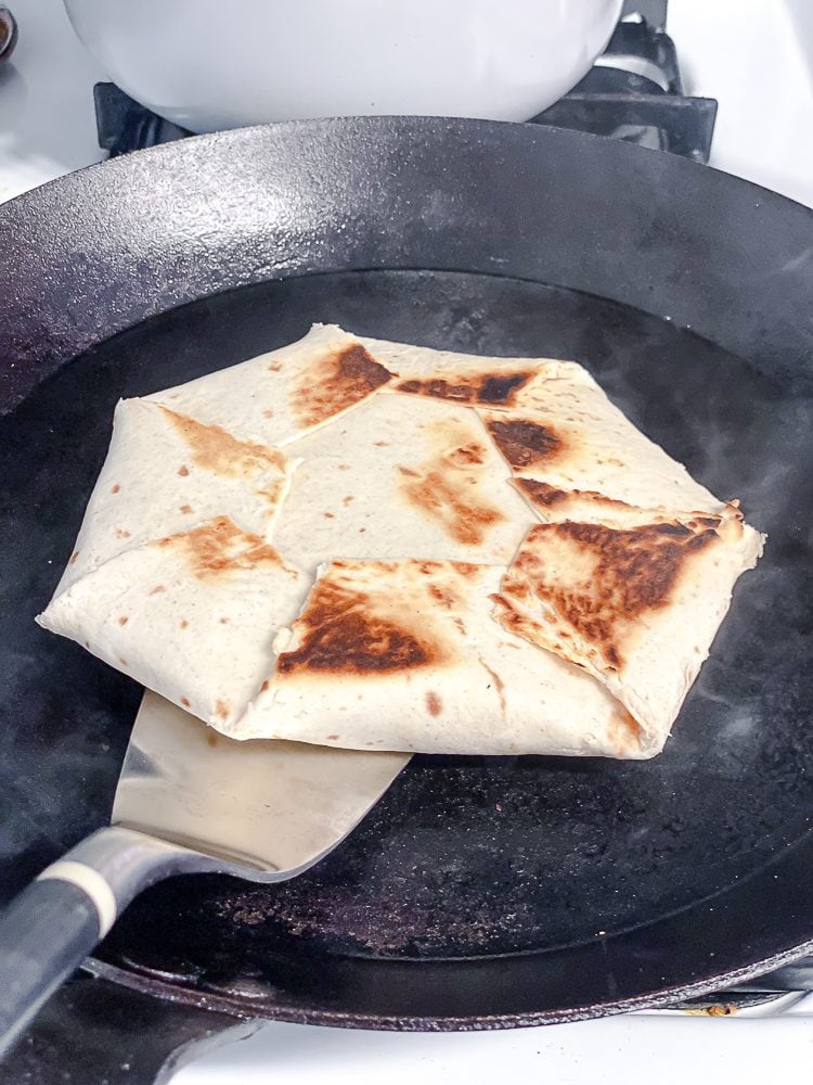 process shot showing flipping crunchwrap on pan