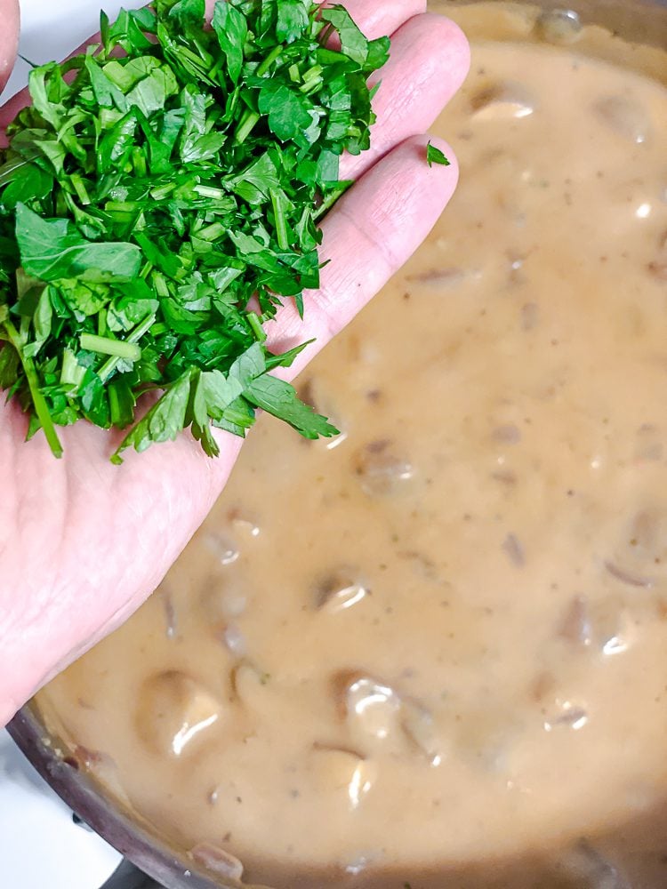 process shot of adding parsley to pot