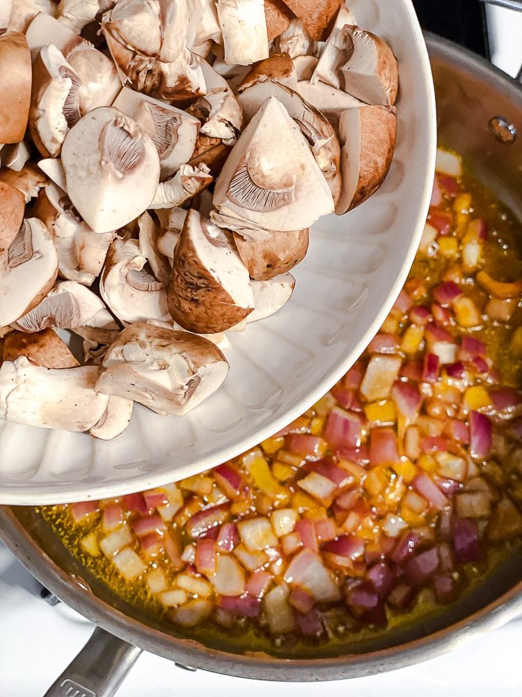 process shot of adding mushrooms to pot