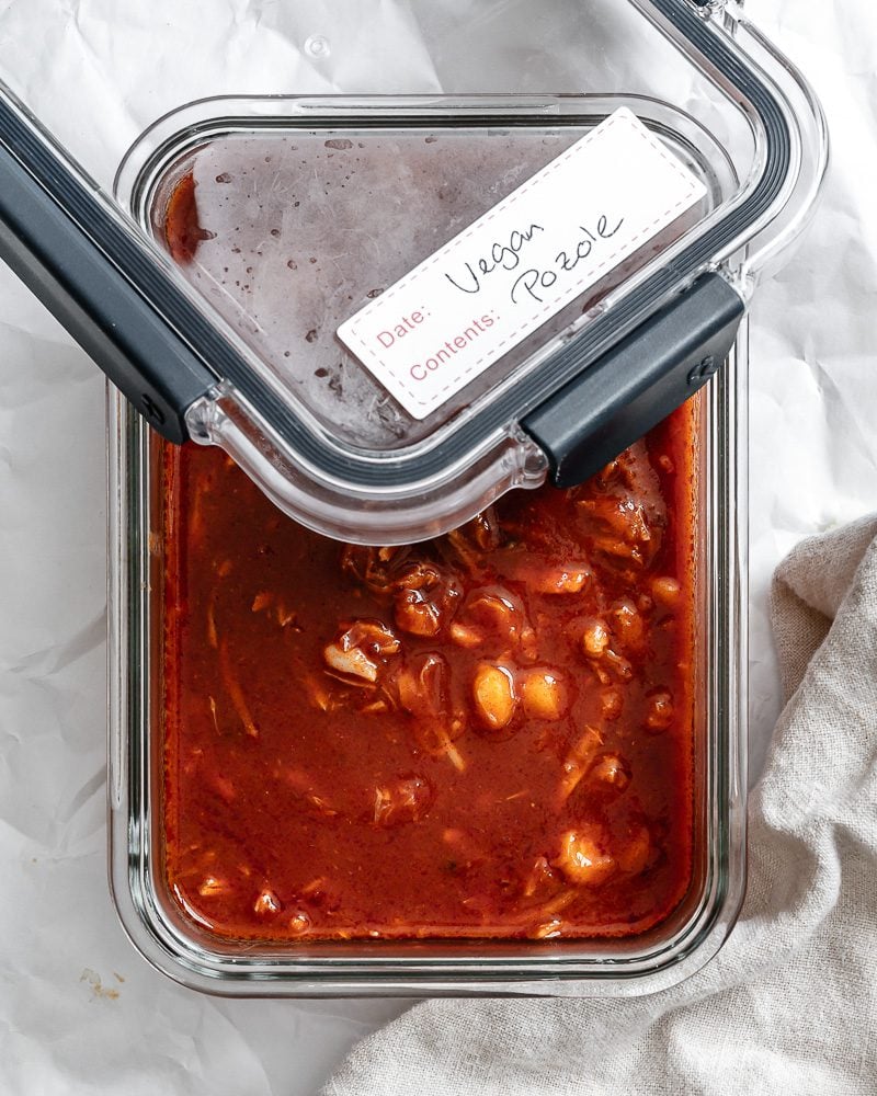 completed Vegan Posole Rojo [Mexican Hominy Soup] in storage container