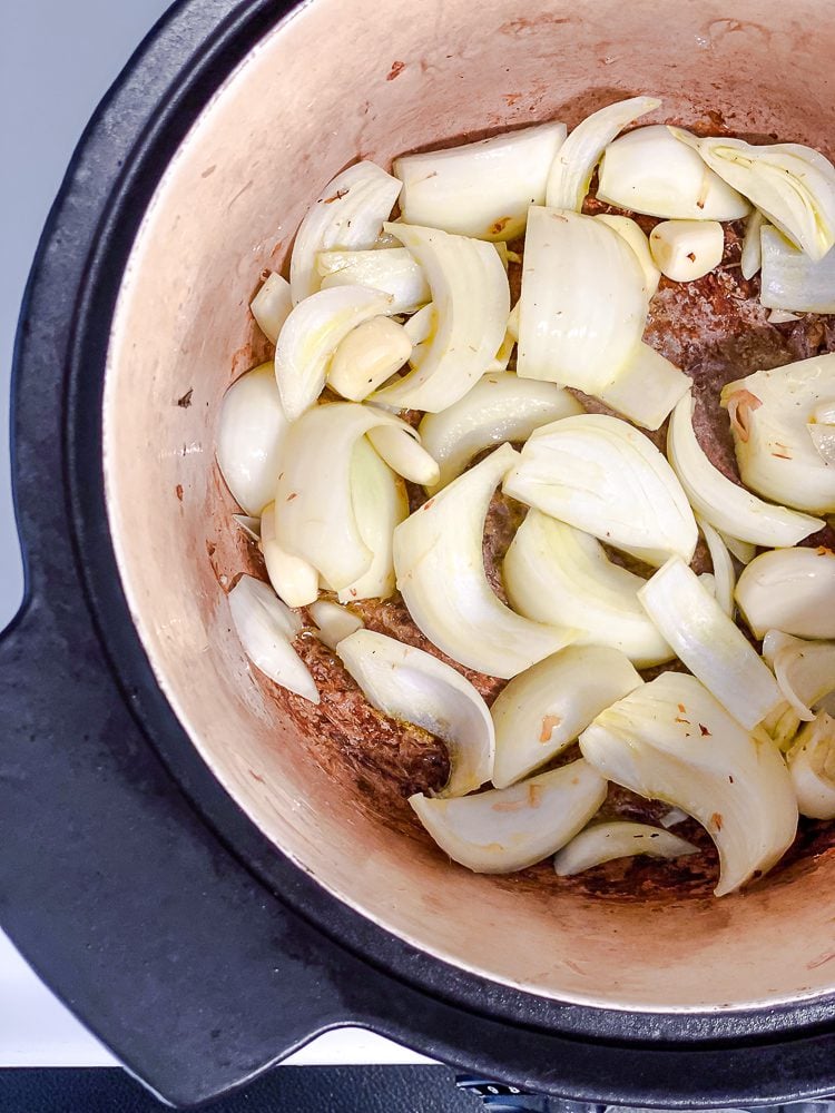 process shot showing garlic cooking in a pot