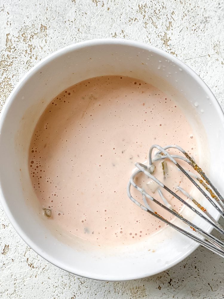 process shot of whisking ingredients together in bowl
