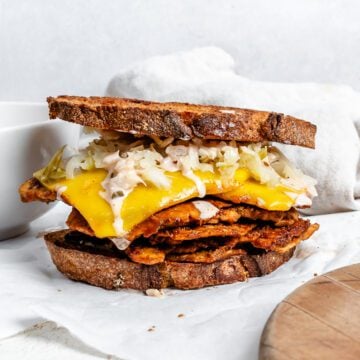 completed Vegan Reuben Sandwich against white surface
