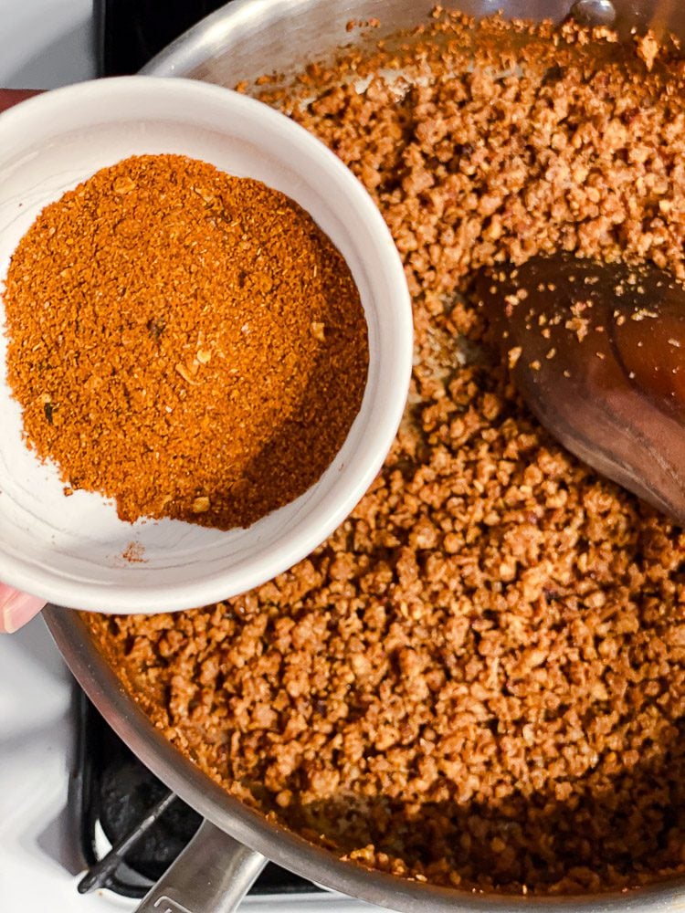 process shot of adding spices to pan