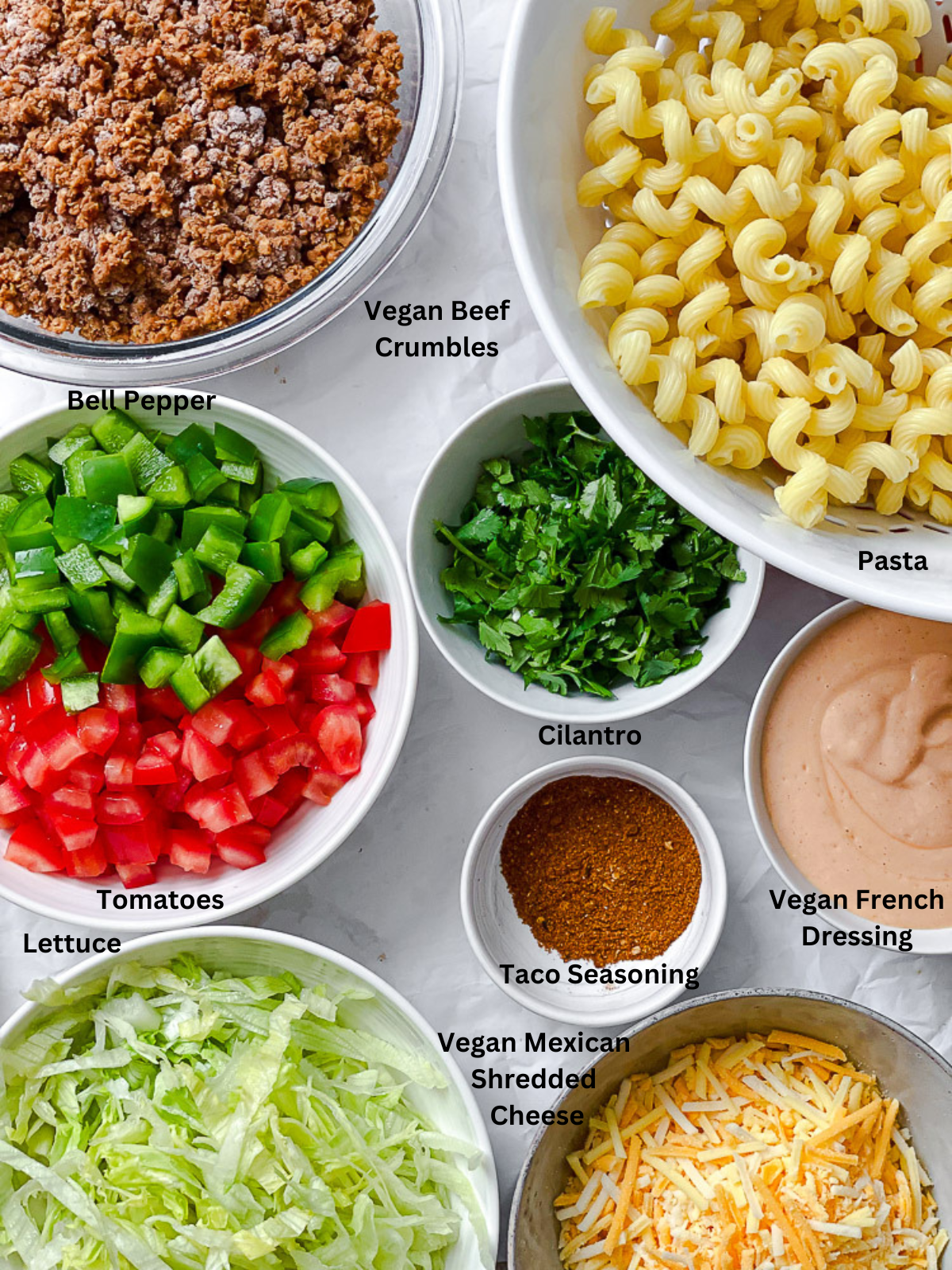 ingredients for Taco Pasta Salad [Without Meat] measured out on a white surface