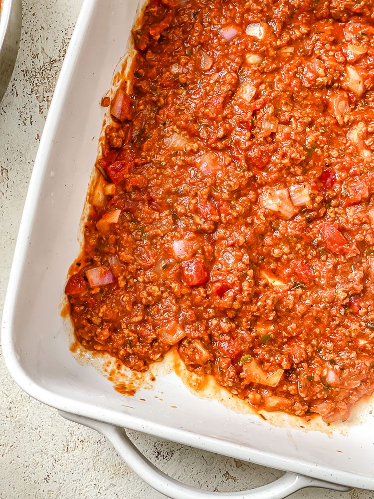 process shot showing sauce added to baking dish