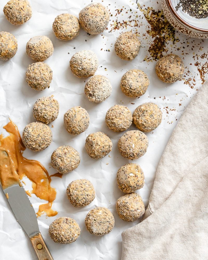completed Peanut Butter Protein Balls with Oatmeal on white surface