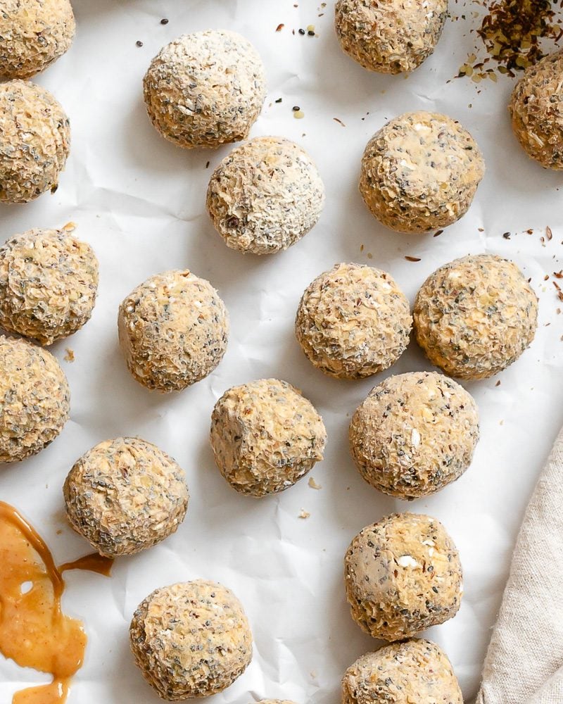completed Peanut Butter Protein Balls with Oatmeal on white surface