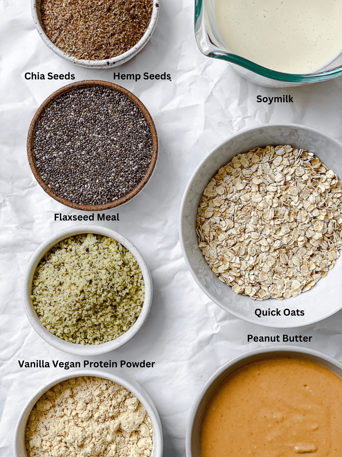 ingredients for Peanut Butter Protein Balls with Oatmeal measured out on white surface
