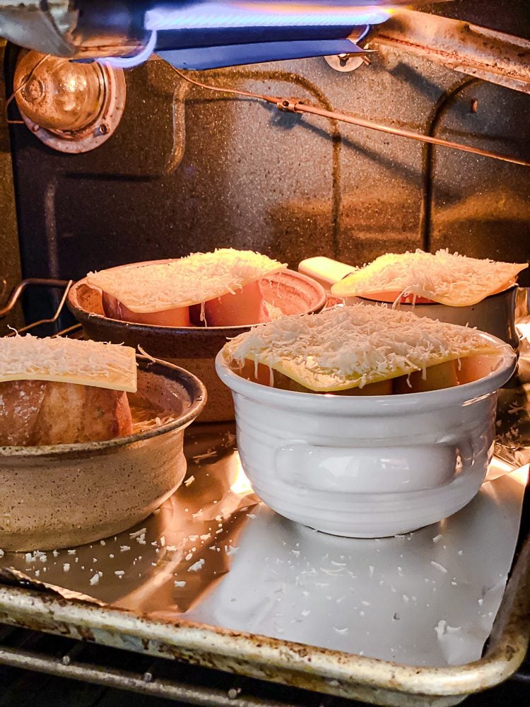 process shot showing bowls of Vegan French Onion Soup in the oven