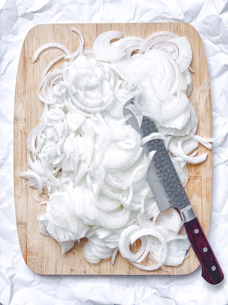 process shot showing slicing onions on cutting board