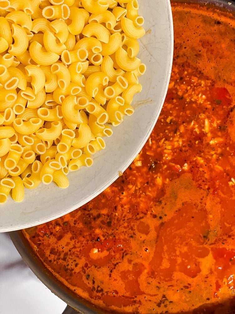 process shot of adding pasta to pan