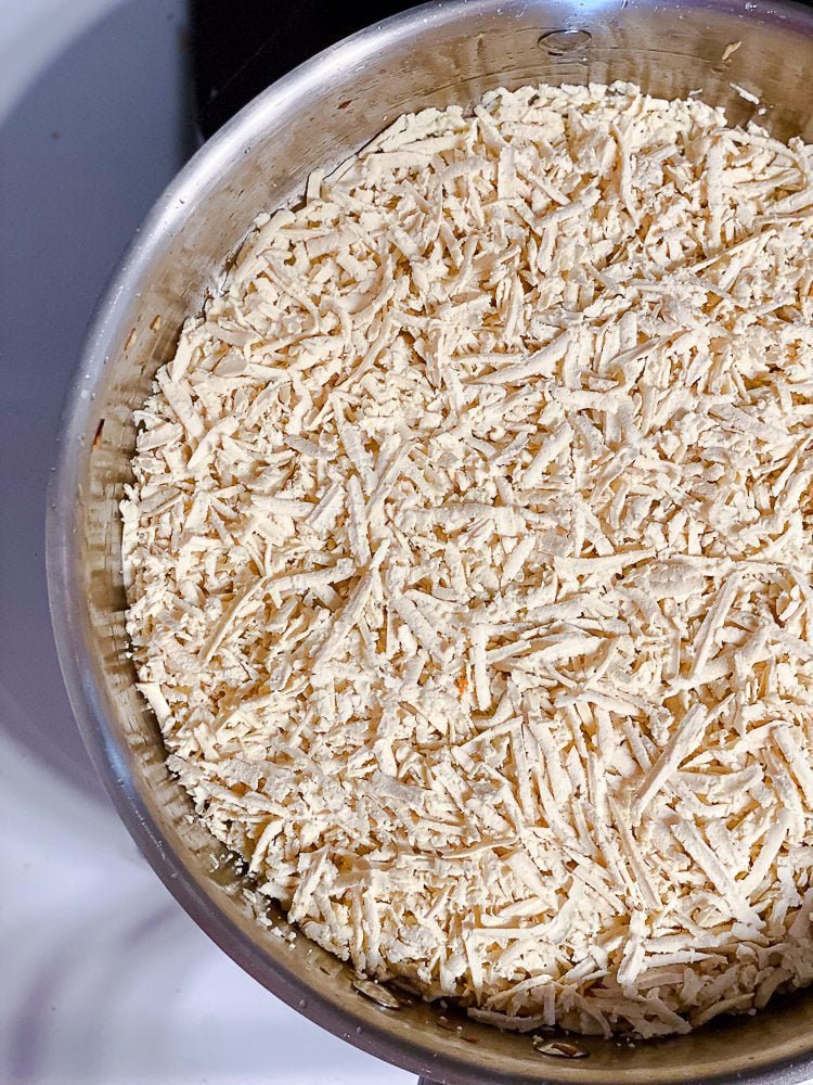 process shot of tofu cooking in pan